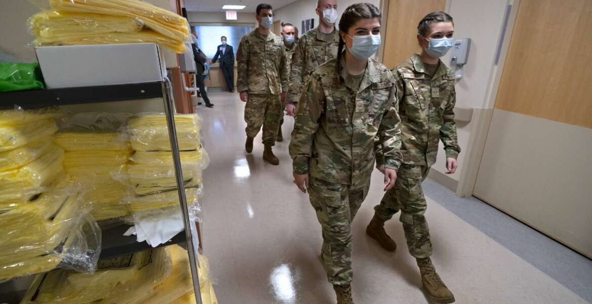 Members of the Maine National Guard arrive for orientation an empty wing at Central Maine Medical Center, Thursday, Dec. 16, 2021, in Lewiston, Maine. The Guard will work as nursing assistants, helping to open a swing bed unit of the hospital that has been closed due to a nursing shortage. (AP Photo/Robert F. Bukaty)