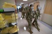 Members of the Maine National Guard arrive for orientation an empty wing at Central Maine Medical Center, Thursday, Dec. 16, 2021, in Lewiston, Maine. The Guard will work as nursing assistants, helping to open a swing bed unit of the hospital that has been closed due to a nursing shortage. (AP Photo/Robert F. Bukaty)