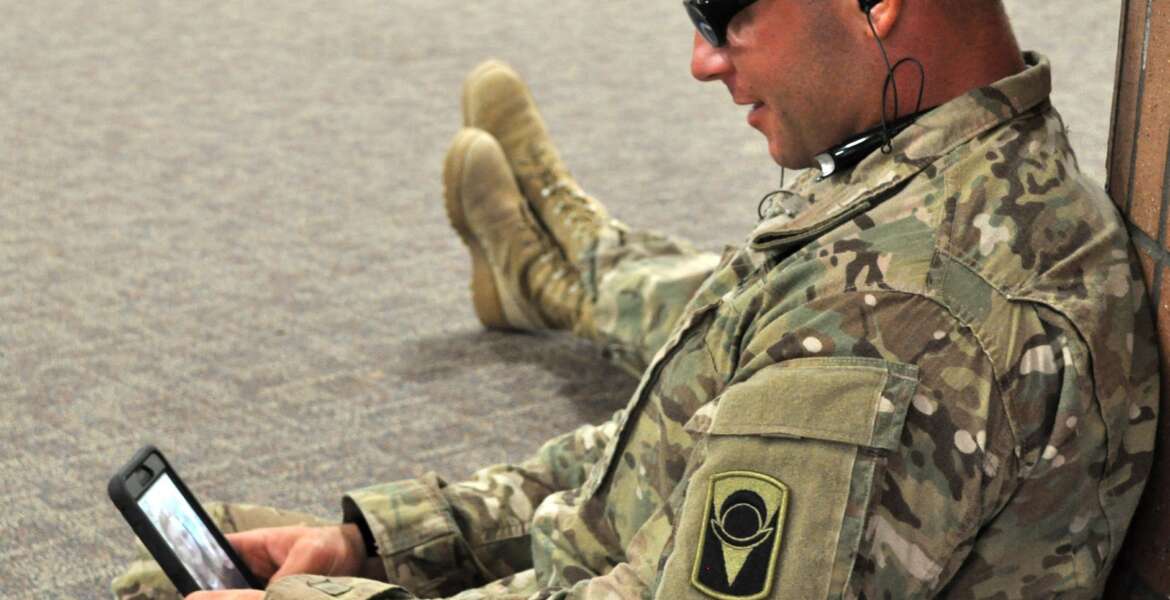Soldier uses the Military OneSource app on his cellphone. (Courtesy of Military OneSource)