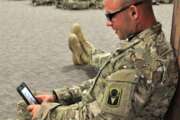 Soldier uses the Military OneSource app on his cellphone. (Courtesy of Military OneSource)