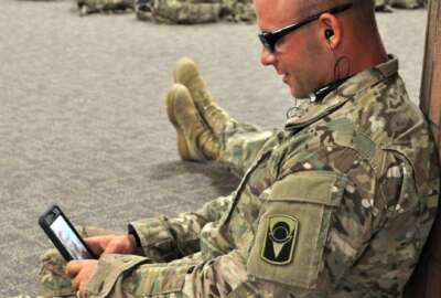 Soldier uses the Military OneSource app on his cellphone. (Courtesy of Military OneSource)