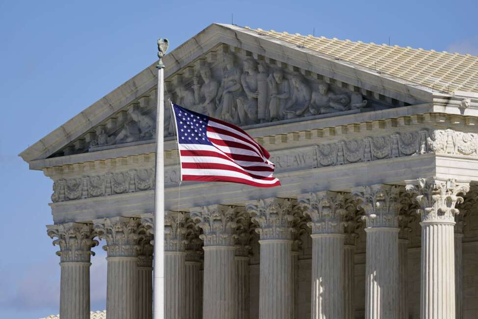 FILE - An American flag waves in front of the Supreme Court building on Capitol Hill in Washington, on Nov. 2, 2020. The Supreme Court on Monday agreed to review a challenge to the consideration of race in college admission decisions, often known as affirmative action. The justices are taking up a pair of lawsuits alleging that Harvard University and the University of North Carolina discriminate against Asian American applicants. (AP Photo/Patrick Semansky, File)