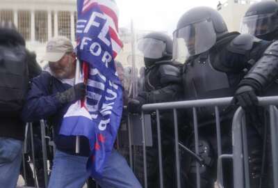 U.S. Capitol Police officers try to hold back rioters on the West Frontof the U.S. Capitol on Jan. 6, 2021, in Washington. (AP Photo/John Minchillo)