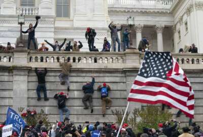 Rioters scale a wall at the U.S. Capitol on Jan. 6, 2021, in Washington. (AP Photo/Jose Luis Magana)