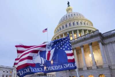 A flag depicting President Donald Trump flies on the East Front of the U.S. Capitol on Jan. 6, 2021, in Washington. (AP Photo/Manuel Balce Ceneta)