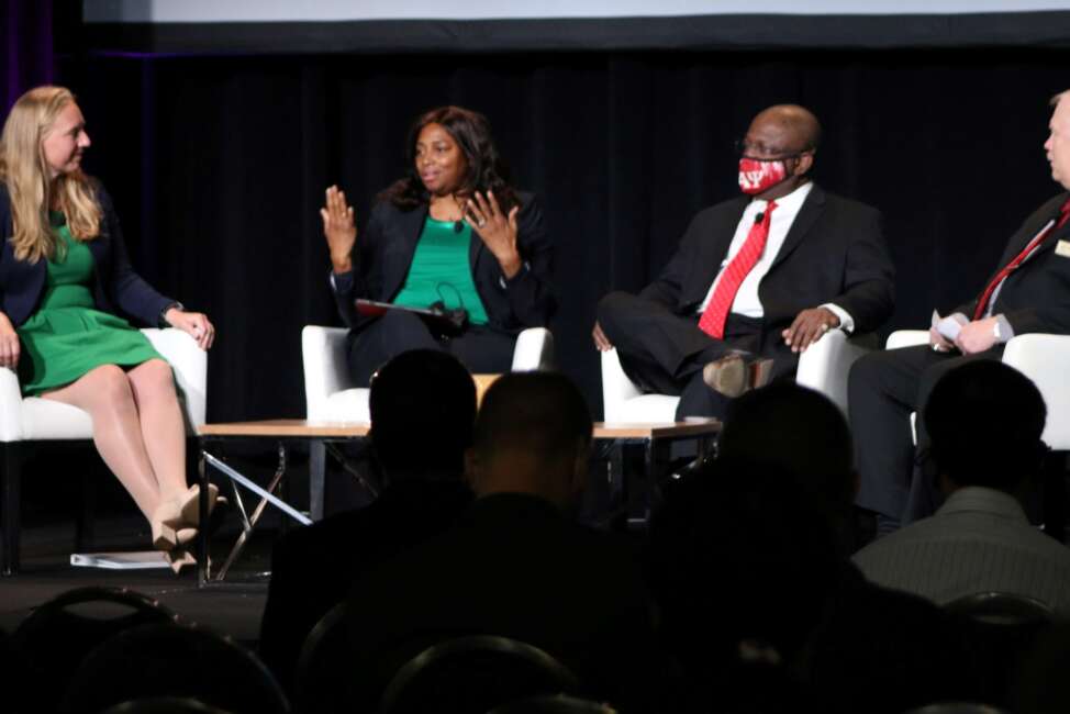 DoD's Kelly Fletcher (left), Vernita Harris and Fred Morefield discuss electromagnetic spectrum at the recent Association of Old Crows International Symposium and Convention.