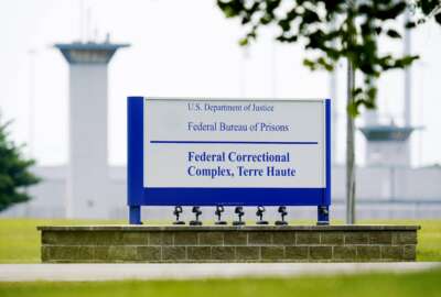 FILE - The federal prison complex in Terre Haute, Ind., Aug. 28, 2020. Days after the head of the troubled federal Bureau of Prisons said he was resigning amid increased scrutiny over his leadership, lawmakers have introduced a bill to require Senate confirmation for future agency directors — the same process used to vet leaders of the FBI and other federal agencies.  (AP Photo/Michael Conroy, File)