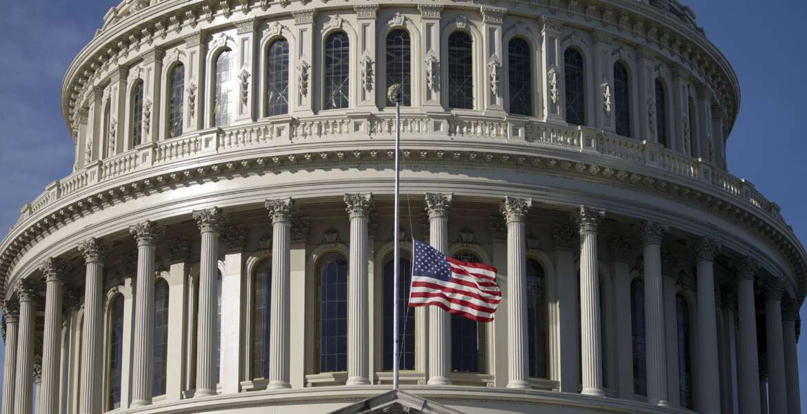 The American flag flies at half-staff outside the U.S. Capitol before a ceremony for former Sen. Harry Reid, D-Nev., Wednesday, Jan. 12, 2022 in Washington. Reid will lie in state at the U.S. Capitol as colleagues and friends pay tribute to a hardscrabble Democrat who served five terms in the Senate. Reid will be honored Wednesday in the Capitol Rotunda during a ceremony closed to the public under COVID-19 protocols. (Al Drago/Pool via AP)