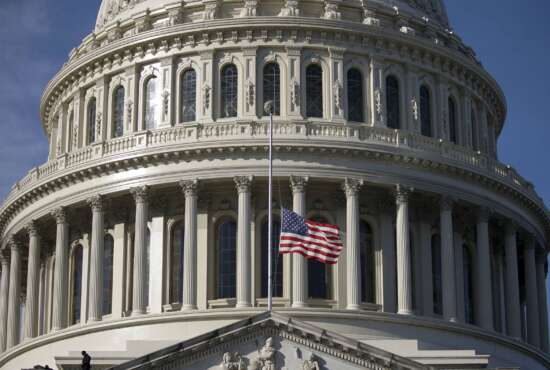 The American flag flies at half-staff outside the U.S. Capitol before a ceremony for former Sen. Harry Reid, D-Nev., Wednesday, Jan. 12, 2022 in Washington. Reid will lie in state at the U.S. Capitol as colleagues and friends pay tribute to a hardscrabble Democrat who served five terms in the Senate. Reid will be honored Wednesday in the Capitol Rotunda during a ceremony closed to the public under COVID-19 protocols. (Al Drago/Pool via AP)