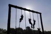 Freshman midshipmen, known as plebes, climb ropes on an obstacle course during Sea Trials, a day of physical and mental challenges that caps off the freshman year at the U.S. Naval Academy in Annapolis, Maryland.