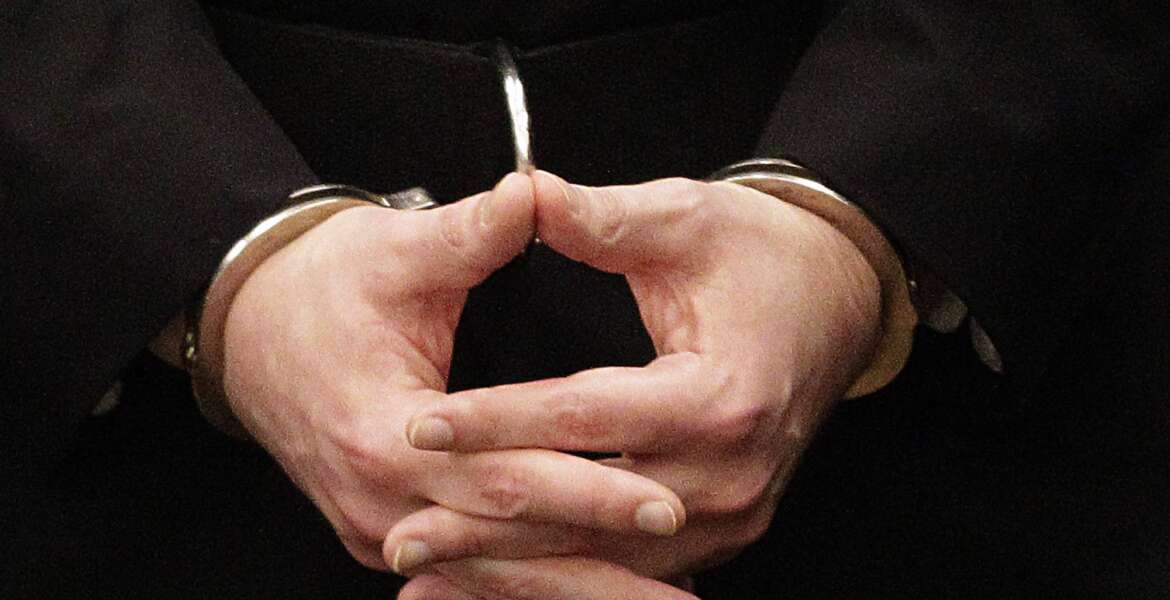 FILE - Convicted mass murderer Anders Behring Breivik, hands are seen in handcuffs as he arrives at the court room in a courthouse in Oslo, Aug. 24, 2012 . A decade after the 2011 bombing and shooting spree that left 77 dead, Breivik is seeking early release from a 21-year sentence — the maximum term in Norway. (AP Photo/Frank Augstein, File)