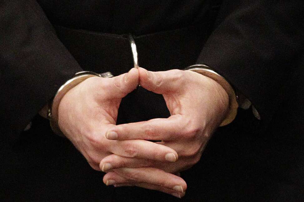 FILE - Convicted mass murderer Anders Behring Breivik, hands are seen in handcuffs as he arrives at the court room in a courthouse in Oslo, Aug. 24, 2012 . A decade after the 2011 bombing and shooting spree that left 77 dead, Breivik is seeking early release from a 21-year sentence — the maximum term in Norway. (AP Photo/Frank Augstein, File)