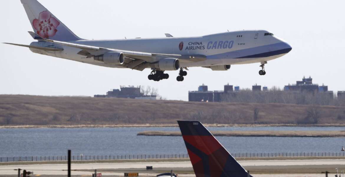 FILE - A China Airlines cargo jet lands at John F. Kennedy International Airport, Saturday, March 14, 2020, in New York. On Monday, Jan. 3, 2022, AT&T and Verizon said they will delay activating new 5G wireless service for two weeks following a request by Transportation Secretary Pete Buttigieg, who cited the airline industry’s concern that the service could interfere with systems on planes. (AP Photo/Kathy Willens, File)