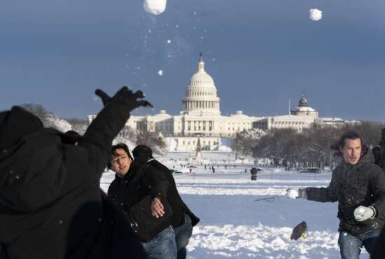Snowballs fly during a snowball fight organized by the DC Snowball Fight Association, on the National Mall, Monday, Jan. 3, 2022, in Washington. (AP Photo/Alex Brandon)