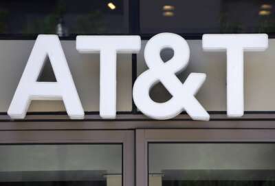 In this Monday, July 29, 2019 photo an AT&T logo sits above an entrance to a building, in Boston. As telecom companies rev up the newest generation of mobile service, called 5G, they’re shutting down old networks — a costly, years-in-the-works process that’s now prompting calls for a delay because a lot of products out there still rely on the old standard, 3G. AT&T in mid-February is the first to shut down the 3G network, which first launched in the U.S. just after the turn of the millennium. AT&T says a delay in retiring the network will hurt its service quality. (AP Photo/Steven Senne)