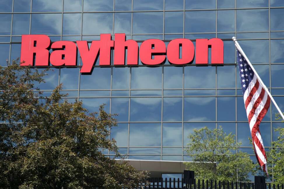 FILE - An American flag flies in front of the facade of Raytheon's Integrated Defense Systems facility, in Woburn, Mass on June 10, 2019. China said Monday, Feb. 21, 2022, it will impose new sanctions on U.S. defense contractors Raytheon Technologies and Lockheed Martin due to their arms sales to Taiwan, stepping up a feud with Washington over security and Beijing’s strategic ambitions. (AP Photo/Elise Amendola, File)