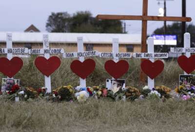 FILE - In this Nov. 10, 2017, file photo, crosses for members of the Holcombe family are part of a makeshift memorial for those who were killed in the Sutherland Springs Baptist Church shooting in Sutherland Springs, Texas. The U.S. Air Force must pay more than $230 million in damages to survivors and victims’ families of a 2017 Texas church massacre for failing to flag a conviction that might have kept the gunman from legally buying the weapon used in the shooting, a federal judge ruled, Monday, Feb. 7, 2022. (AP Photo/Eric Gay, File)