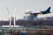 FILE - Passenger flights land and take off at Reagan Washington National Airport in Arlington, Va., across the Potomac River from Washington, Wed., Jan. 19, 2022.  A congressional committee is looking into the controversy over the launch of new high-speed wireless service and whether it poses any threat to airline safety. A House committee on Thursday, Feb. 3,  heard testimony from the head of the Federal Aviation Administration, airline groups and a trade group for telecommunications companies.   (AP Photo/J. Scott Applewhite, File)