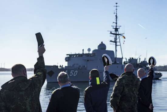 Navy soldiers wave to the naval service boat 
