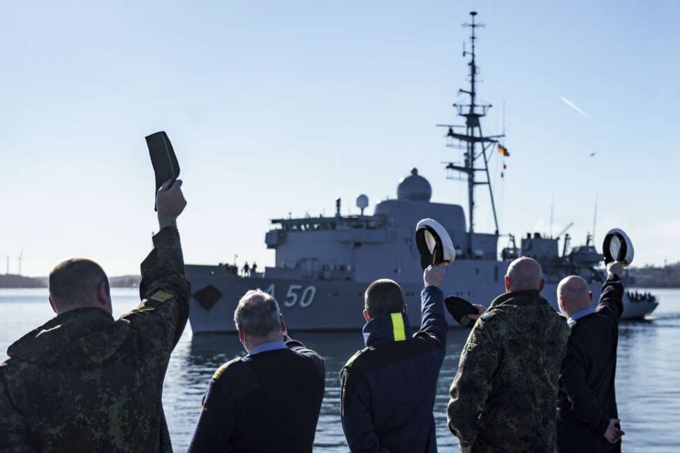 Navy soldiers wave to the naval service boat "Alster", which is leaving the naval port to reinforce the NATO northern flank, Eckernfoerde, Germany, Saturday, Feb. 26, 2022. In view of Russia's attack on Ukraine, the German Navy sends the reconnaissance ship "Alster" to reinforce NATO's northern flank. (Axel Heimken/dpa via AP)