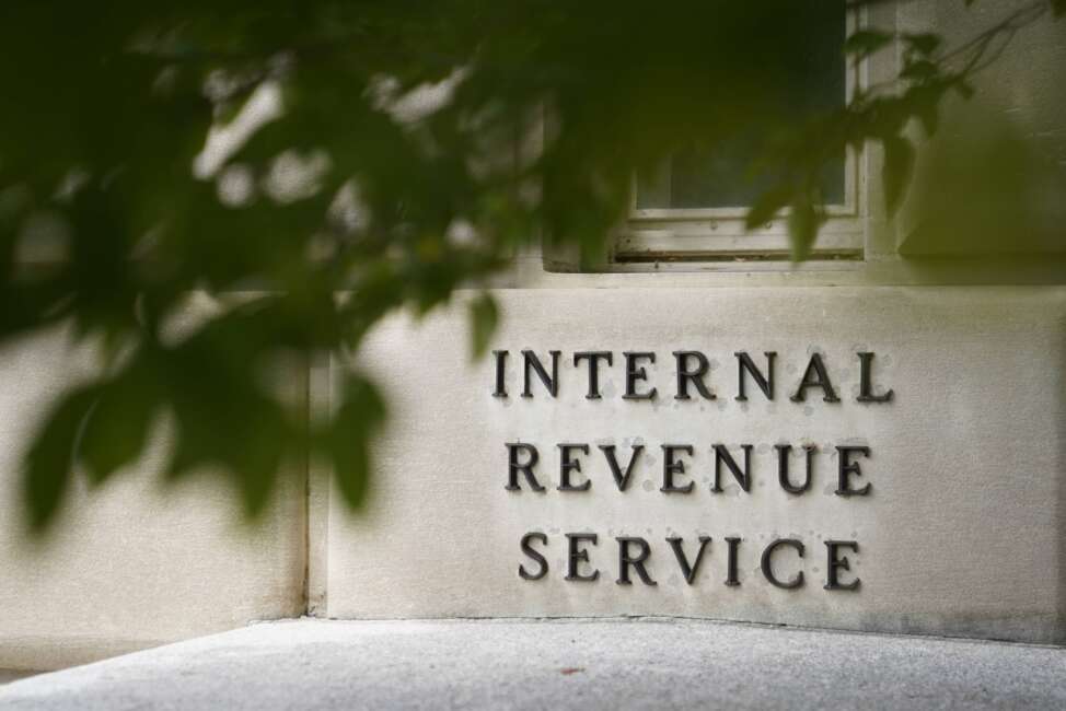 FILE - A sign is displayed outside the Internal Revenue Service building May 4, 2021, in Washington. A private company, enQ, lets those who are willing to pay jump to the front of the line to get their phone calls answered at the IRS. That has attracted the attention of lawmakers who want the IRS to investigate the company's impact on the agency's phone capacity. (AP Photo/Patrick Semansky, File)