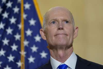 FILE - Sen. Rick Scott, R-Fla., talks with reporters on Capitol Hill in Washington, on Jan. 20, 2022. He was talking about President Joe Biden's first year as president. Two widely supported bills are encountering delays in the Senate. The House easily approved the measures last week with broad bipartisan support. (AP Photo/Susan Walsh, File)