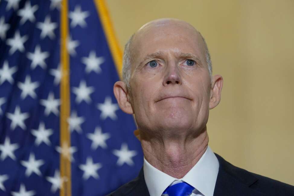 FILE - Sen. Rick Scott, R-Fla., talks with reporters on Capitol Hill in Washington, on Jan. 20, 2022. He was talking about President Joe Biden's first year as president. Two widely supported bills are encountering delays in the Senate. The House easily approved the measures last week with broad bipartisan support. (AP Photo/Susan Walsh, File)