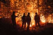 FILE -Firefighters work at the scene of forest fire near Kyuyorelyakh village at Gorny Ulus area, west of Yakutsk, in Russia Thursday, Aug. 5, 2021. A warming planet and land use changes mean more wildfires will scorch large parts of the globe in coming decades. That's according to a UN report released Wednesday, Feb. 23, 2022 that says many governments are ill-prepared to address the problem.  (AP Photo/Ivan Nikiforov, File)