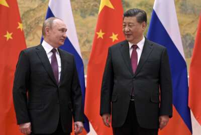 FILE - Chinese President Xi Jinping, right, and Russian President Vladimir Putin talk to each other during their meeting in Beijing, Feb. 4, 2022. China is the only friend that might help Russia blunt the impact of economic sanctions over its invasion of Ukraine, but President Xi Jinping’s government is giving no sign it might be willing to risk its own access to U.S. and European markets by doing too much. (Alexei Druzhinin, Sputnik, Kremlin Pool Photo via AP, File)