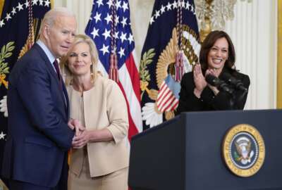 President Joe Biden talks with Gretchen Carlson as Vice President Kamala Harris applauds before Biden signs a bill to end forced arbitration in sexual harassment cases in the workplace, Thursday, March 3, 2022, in the East Room of the White House in Washington. (AP Photo/Patrick Semansky)
