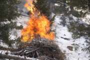 Flames rise from a pile of tree debris near the Bridge Crossing picnic grounds in Hatch Gulch Wednesday, Feb. 23, 2022, near Deckers, Colo. In Colorado, climate change means snow is not always on the ground when needed so that crews can safely burn off debris piles and vegetation to help keep future wildfires from becoming catastrophic. 
 (AP Photo/David Zalubowski)