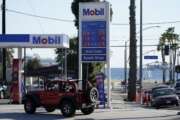 FILE - Gas prices are displayed at a gas station Friday, March 11, 2022, in Long Beach, Calif.  Rebates or cash payments are being proposed in California, New Mexico, Pennsylvania and elsewhere as states are flush with cash and Americans are facing the highest inflation in four decades. (AP Photo/Ashley Landis, File)