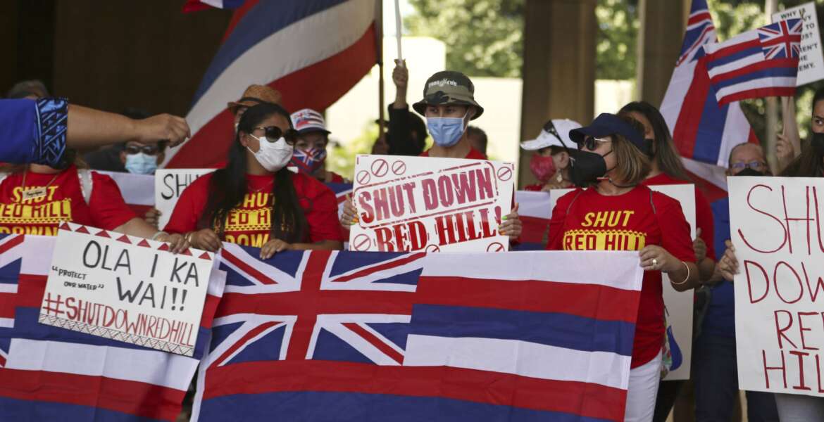 A group of demonstrators gather at the Hawaii state capitol for a rally over water contamination by the U.S. Navy near Pearl Harbor on Feb. 11, 2022, in Honolulu. Native Hawaiians who revere water in all its forms as the embodiment of a Hawaiian god say the Navy's acknowledgement that jet fuel leaked into Pearl Harbor's tap water has deepened the distrust they feel toward the U.S. military. (AP Photo/Caleb Jones)