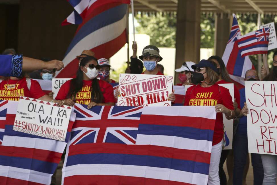 A group of demonstrators gather at the Hawaii state capitol for a rally over water contamination by the U.S. Navy near Pearl Harbor on Feb. 11, 2022, in Honolulu. Native Hawaiians who revere water in all its forms as the embodiment of a Hawaiian god say the Navy's acknowledgement that jet fuel leaked into Pearl Harbor's tap water has deepened the distrust they feel toward the U.S. military. (AP Photo/Caleb Jones)