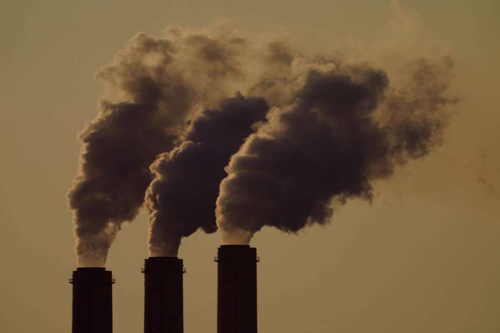 FILE - Emissions rise from the smokestacks at the Jeffrey Energy Center coal power plant as the suns sets, near Emmett, Kan., Sept. 18, 2021.  In a victory for President Joe Biden, a federal appeals court Thursday, April 14, 2022 refused to revisit its March decision reviving administration plans to account for potential damage from greenhouse gas emissions when creating rules for polluting industries. (AP Photo/Charlie Riedel, File)