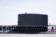 Members of the U.S. Navy stand on the USS Delaware, Virginia-class fast-attack submarine, during a commissioning ceremony at the Port of Wilmington in Wilmington, Del., Saturday, April 2, 2022. (AP Photo/Carolyn Kaster)