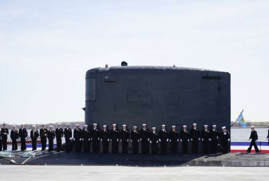 Members of the U.S. Navy stand on the USS Delaware, Virginia-class fast-attack submarine, during a commissioning ceremony at the Port of Wilmington in Wilmington, Del., Saturday, April 2, 2022. (AP Photo/Carolyn Kaster)