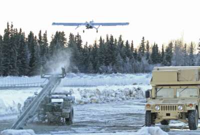 FILE - In this Jan. 30, 2014 photo, an RQ7 Shadow unmanned aircraft flies from its pneumatic catapult launcher at Joint Base Elmendorf-Richardson in Anchorage, Alaska. U.S. military bases in the Arctic and sub-Arctic are failing to harden their installations against long-term climate change as required, even though soaring temperatures and melting ice already are cracking base runways and roads and worsening flood risks up north, the Pentagon's watchdog office said April 14, 2022. (AP Photo/Dan Joling, File)