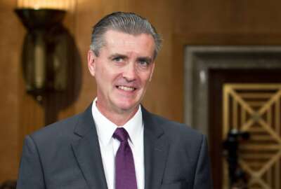 FILE - U.S. Ambassador to Pakistan-nominee Richard G. Olson, arrives for his confirmation hearing before the Senate Foreign Relations Committee, July 31, 2012, in Washington. Olson, a former top-ranking State Department official is set to plead guilty for improperly helping a wealthy Gulf country try to influence U.S. policy and not disclosing on a government ethics form gifts he received from a disgraced political fundraiser. (AP Photo/J. Scott Applewhite, File)
