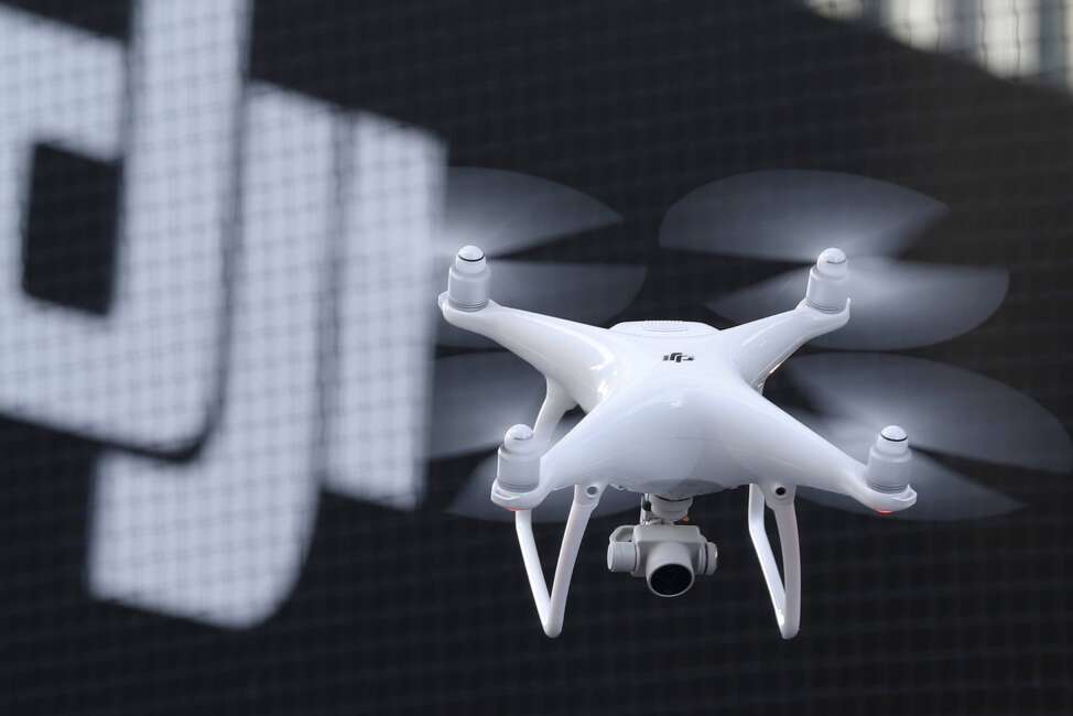 FILE - A Phantom 4, developed by major Chinese consumer-drone maker DJI, flies during its demonstration flight in Tokyo, Thursday, March 3, 2016. Drone company DJI Technology Co said Tuesday, April 27, 2022, that it has temporarily suspended business activities in Russia and Ukraine to prevent use of its drones in combat, in a rare case of a Chinese company pulling out of Russia. (AP Photo/Shizuo Kambayashi, File)