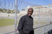 Former inmate Richard "Bonaru" Richardson talks about his experiences while standing between the exercise yard and classrooms of Mount Tamalpais College at San Quentin State Prison on April 12, 2022, in San Quentin, Calif. The community college, the first in California with a campus inside a prison, is the latest addition to San Quentin's numerous rehabilitation programs that have made it a desired destination for inmates throughout the state. Since his release, he has been working for the newly formed college as an advancement associate, helping with fundraising and the college's website. (AP Photo/Eric Risberg)