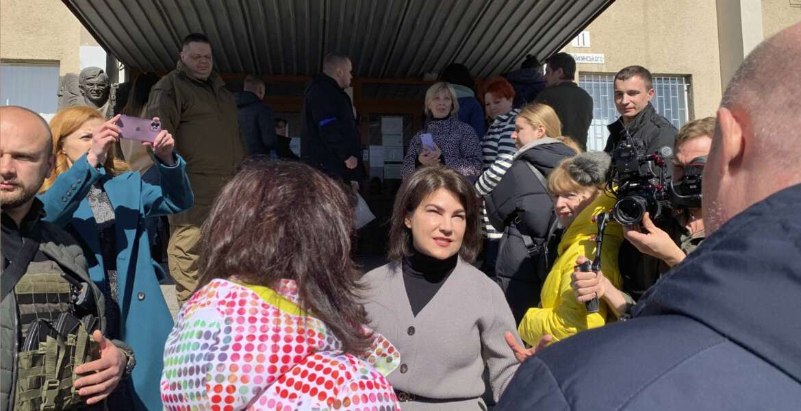 Ukraine’s Prosecutor General Iryna Venediktova speaks with refugees outside a processing center in Lviv, Ukraine on March 22, 2022. She has stationed prosecutors at refugee centers across the country and at border crossings to extract evidence from millions of displaced Ukrainians and register them as victims potentially eligible for compensation. (AP Photo/Erika Kinetz)
