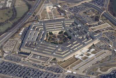 FILE - The Pentagon is seen from Air Force One as it flies over Washington, March 2, 2022. The U.S. military says explosions earlier this month on a base in eastern Syria that injured several U.S. service members were not, as it originally reported, caused by artillery or another form of indirect fire. Instead, it is now believed the April 7 attack was carried out by the “deliberate placement of explosive charges” by one or more individuals at an ammunition holding area and shower facility on the base, according to a statement issued Thursday by the Operation Inherent Resolve command that oversees U.S. military operations against the Islamic State group in Syria and Iraq. (AP Photo/Patrick Semansky, File)