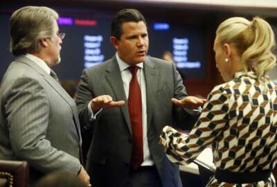 State Sens., from left, Gary Farmer, D-Lighthouse Point, Jason Pizzo, D-North Miami Beach and Lauren Book, D-Plantation confer during debate on Senate Bill CS/SB 2-D: Property Insurance in the Florida Senate Tuesday, May 24, 2022 at the Capitol in Tallahassee, Fla. (AP Photo/Phil Sears)
