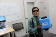 Rajiv Shah, an assistive technology specialist at the State Department's Access Center, holds a throwable microphone designed for conferences and group meetings. (Jory Heckman/Federal News Network).