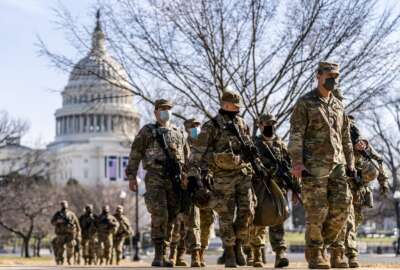 FILE - Members of the National Guard patrol outside the Capitol Building on Capitol Hill in Washington, on Jan. 14, 2021. The Department of Justice has given the green light to National Guard members on active duty for their states to join labor unions, despite a U.S. law that makes it a felony for military personnel on active federal duty to unionize. (AP Photo/Andrew Harnik, File)