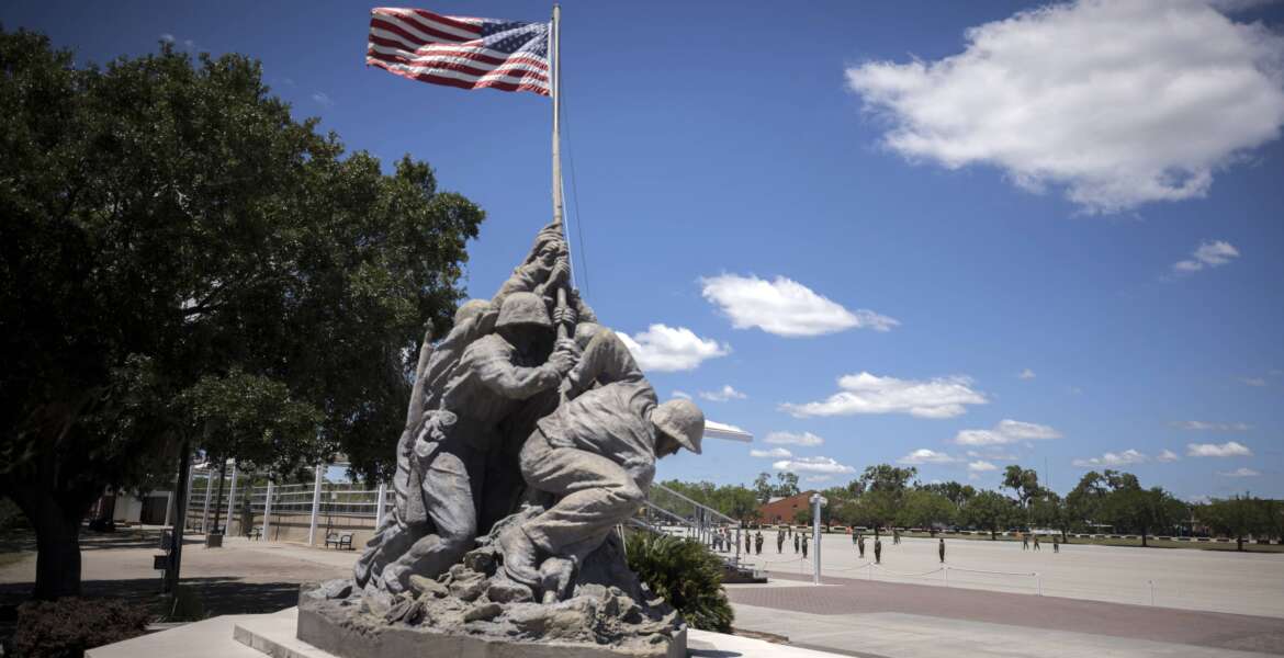 A smaller scale replica of the Marine Corps War Memorial statue stands near the parade ground at the Marine Corps Recruiting Depot, Wednesday, May 11, 2022, in Parris Island, S.C. The threat of rising seas is encroaching upon one of America's most storied military installations, where thousands of recruits are molded into Marines each year. (AP Photo/Stephen B. Morton)