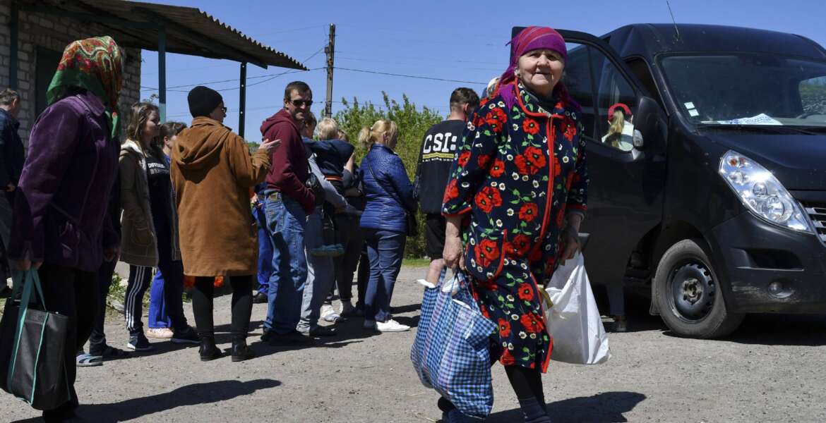 People receive humanitarian aid in Kramatorsk, Ukraine, Saturday, May 7, 2022. (AP Photo/Andriy Andriyenko)