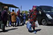 People receive humanitarian aid in Kramatorsk, Ukraine, Saturday, May 7, 2022. (AP Photo/Andriy Andriyenko)