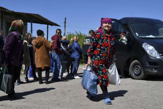 People receive humanitarian aid in Kramatorsk, Ukraine, Saturday, May 7, 2022. (AP Photo/Andriy Andriyenko)